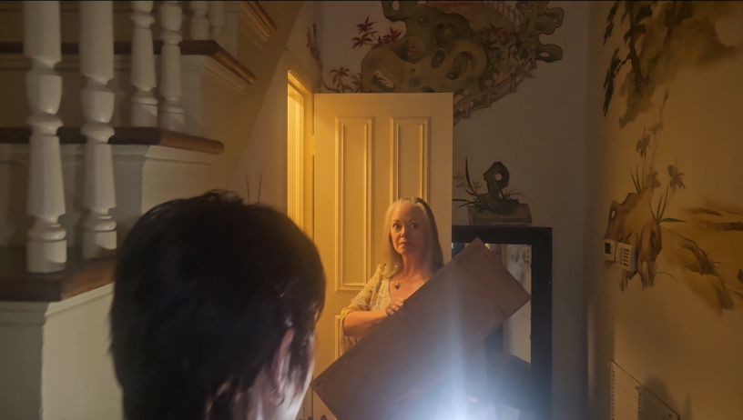 Carrie Genzel and spiritual medium Morrighan Lynne investigate the closet inside the historic Slate Row Houses in Macon, Georgia.