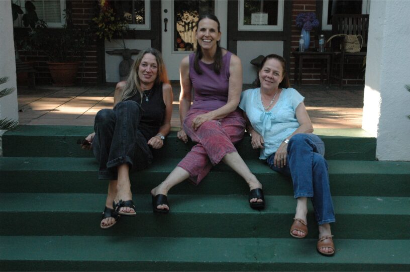 Linda Oakley, Kirsten West, and Judi Petty sitting on the front steps of The Big House in Macon, Georgia, circa 2004.