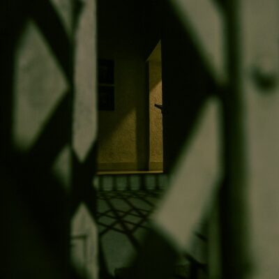 Shadowy figure in a dark basement representing spirits hiding during a paranormal investigation