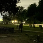Historic San Antonio cemetery at night with illuminated headstones