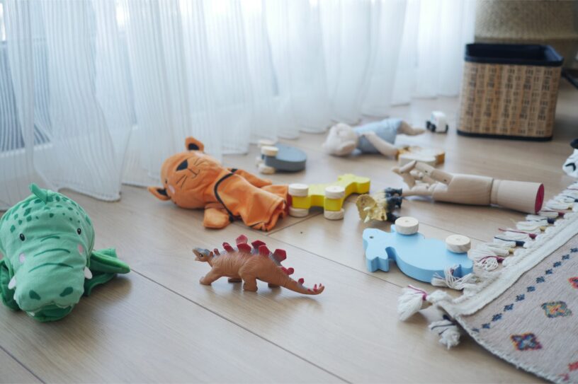 Children's toys scattered across the floor of a room